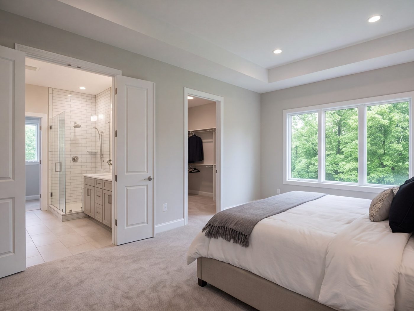Primary bedroom suite with a connected bath and walk-in closet seen from the bedroom